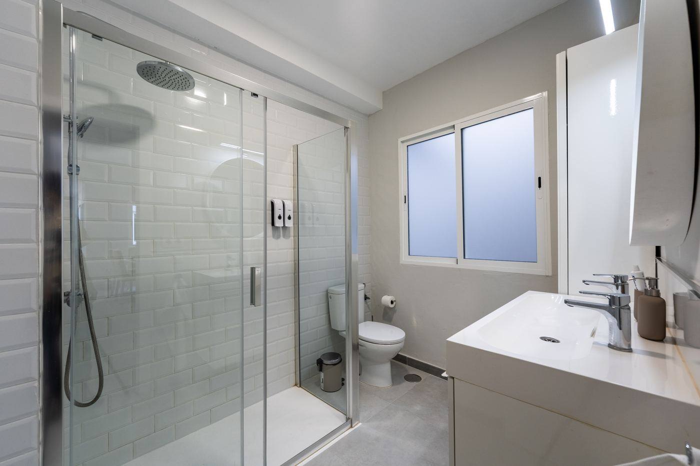 Bathroom with walk-in shower and window
