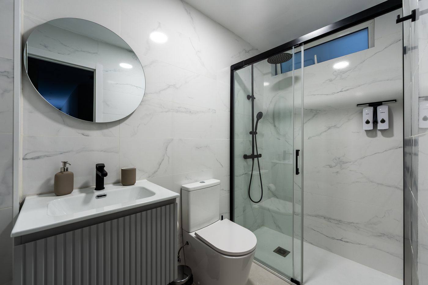 Modern bathroom with walk-in shower and oval mirror