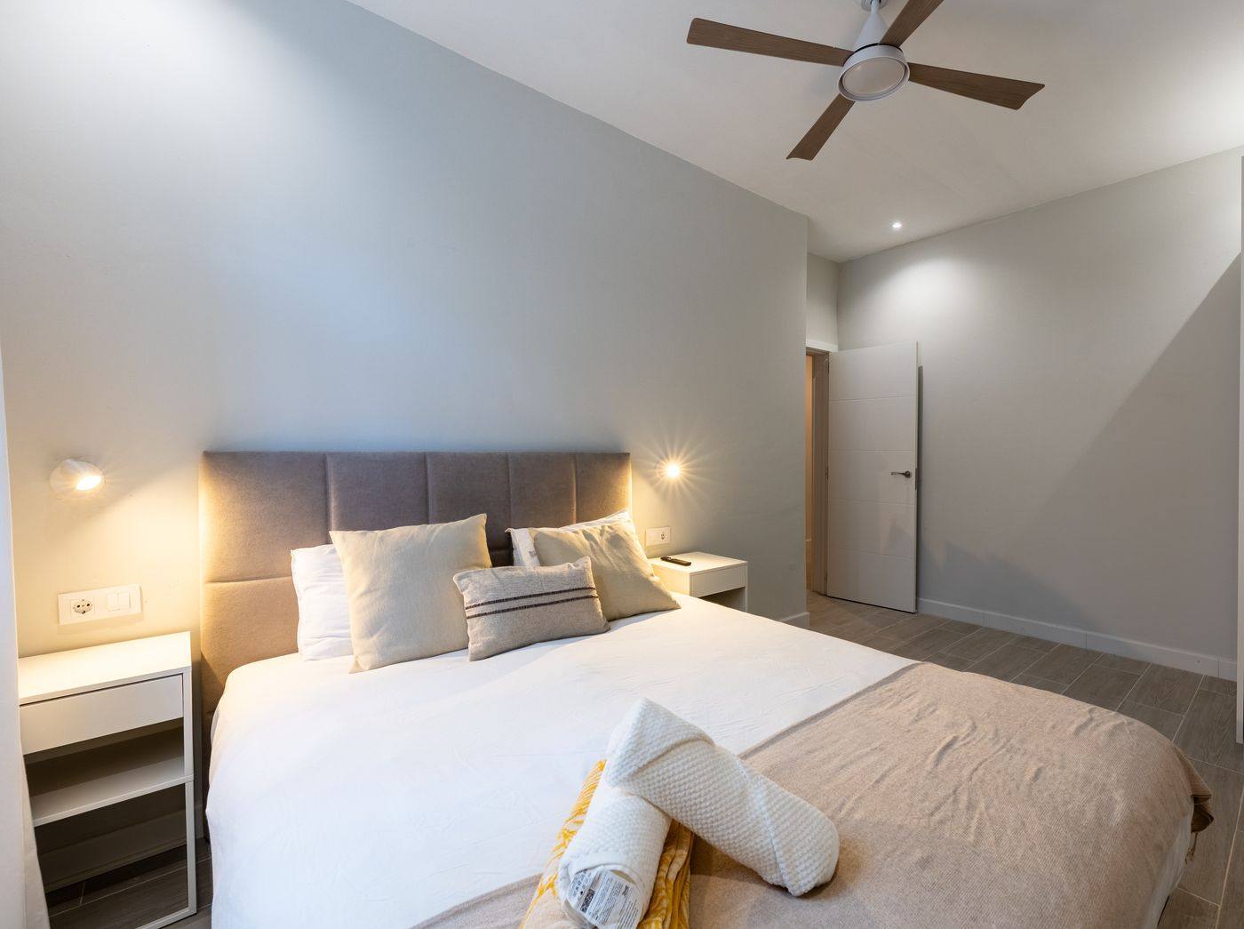 Double bed with upholstered headboard and bedside tables